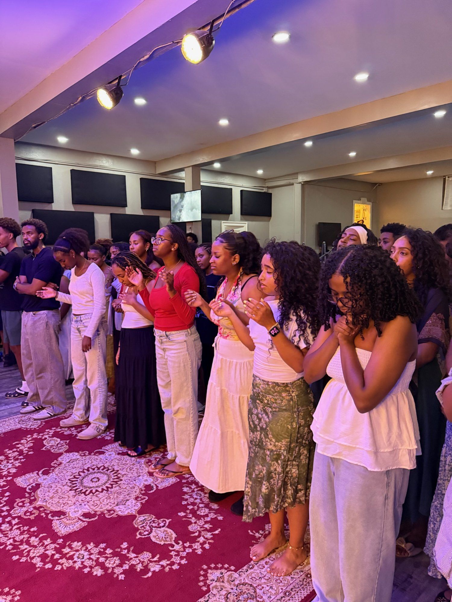 Young women from MBEC Young Adults praying together